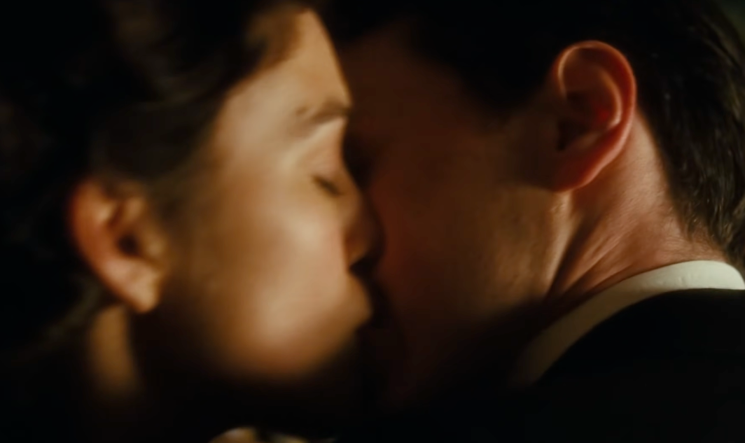 A close-up of 2 unidentified radical sharing an intimate kiss