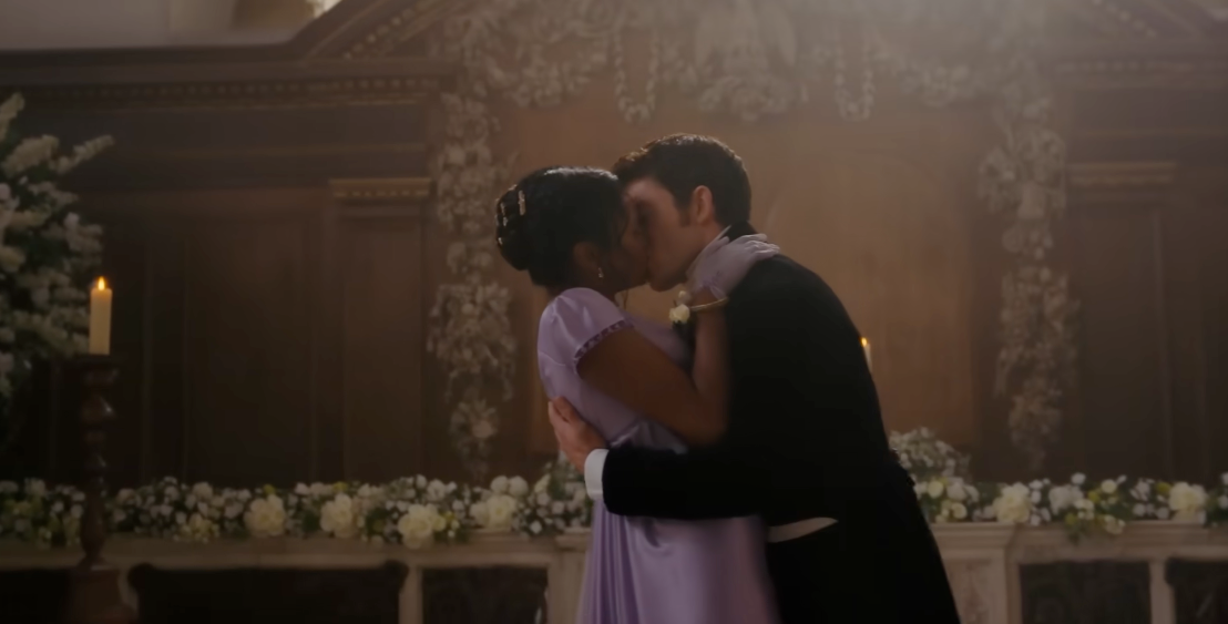 A mates successful elegant play costumes kisses successful beforehand of an ornate altar adorned with flowers and candles