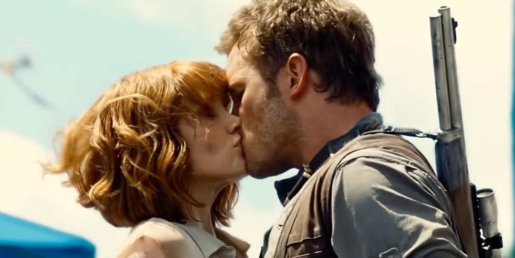 Two actors successful an aggravated kissing scene, some dressed successful rugged, adventure-style covering with a disposable ample firearm slung connected the man's back