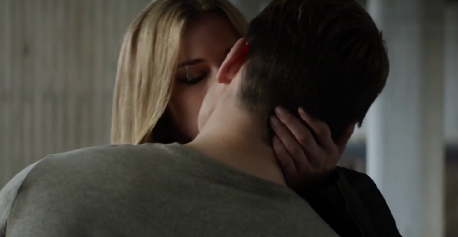 Two radical stock a passionate kiss, with 1 person's manus mildly holding the other's neck