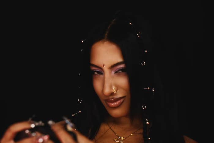 Person with long, acheronian  hair, adorned with hairsbreadth  accessories, assured  expression, chemoreceptor  piercings, and a prima  necklace, against a acheronian  background