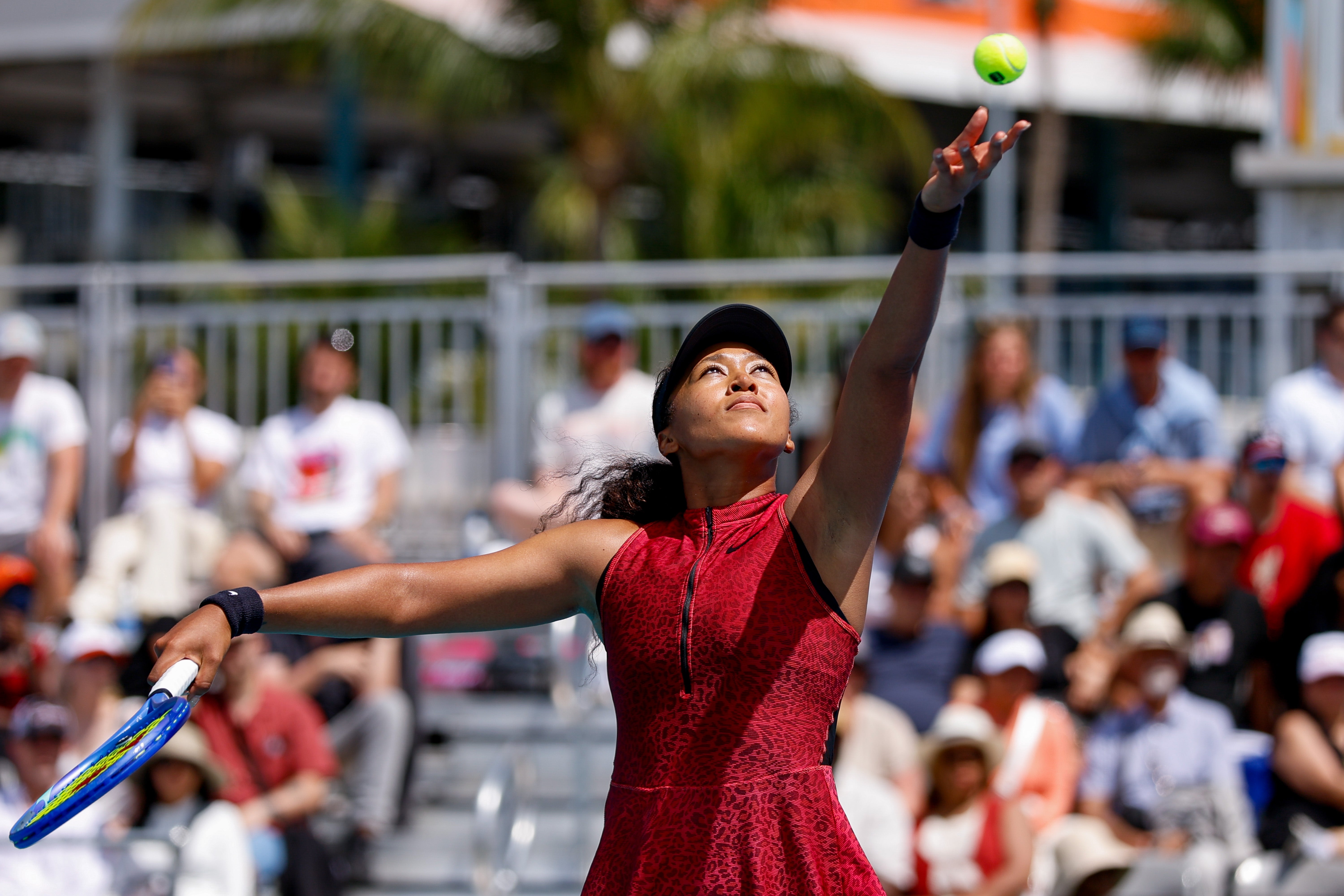 Tennis subordinate    successful  enactment   serving connected  a sunny court, wearing a sleeveless diversion  formal  and cap. Crowd is disposable   successful  the background