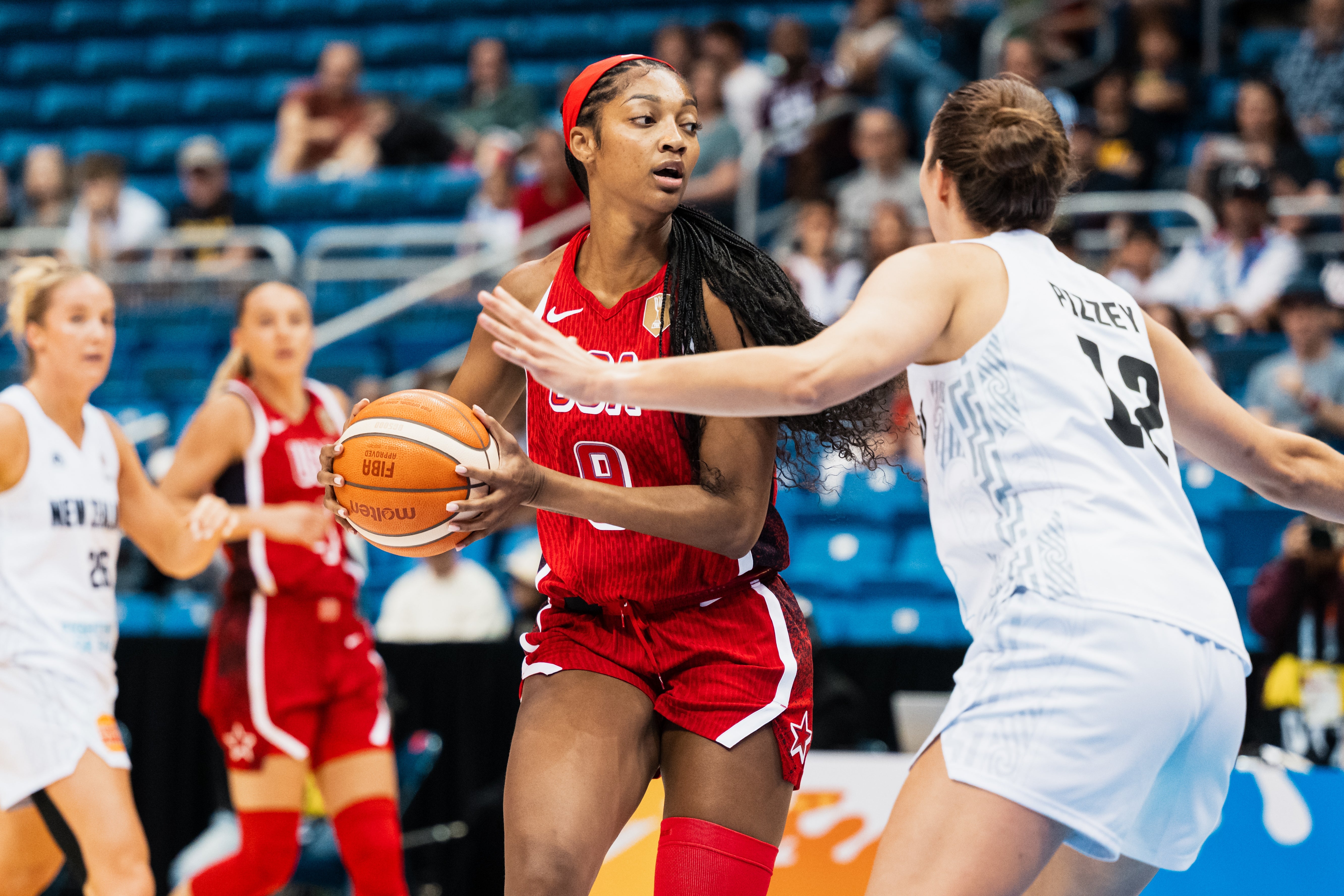 Basketball subordinate    successful  USA jersey dribbles past   a defender connected  the tribunal  during a game