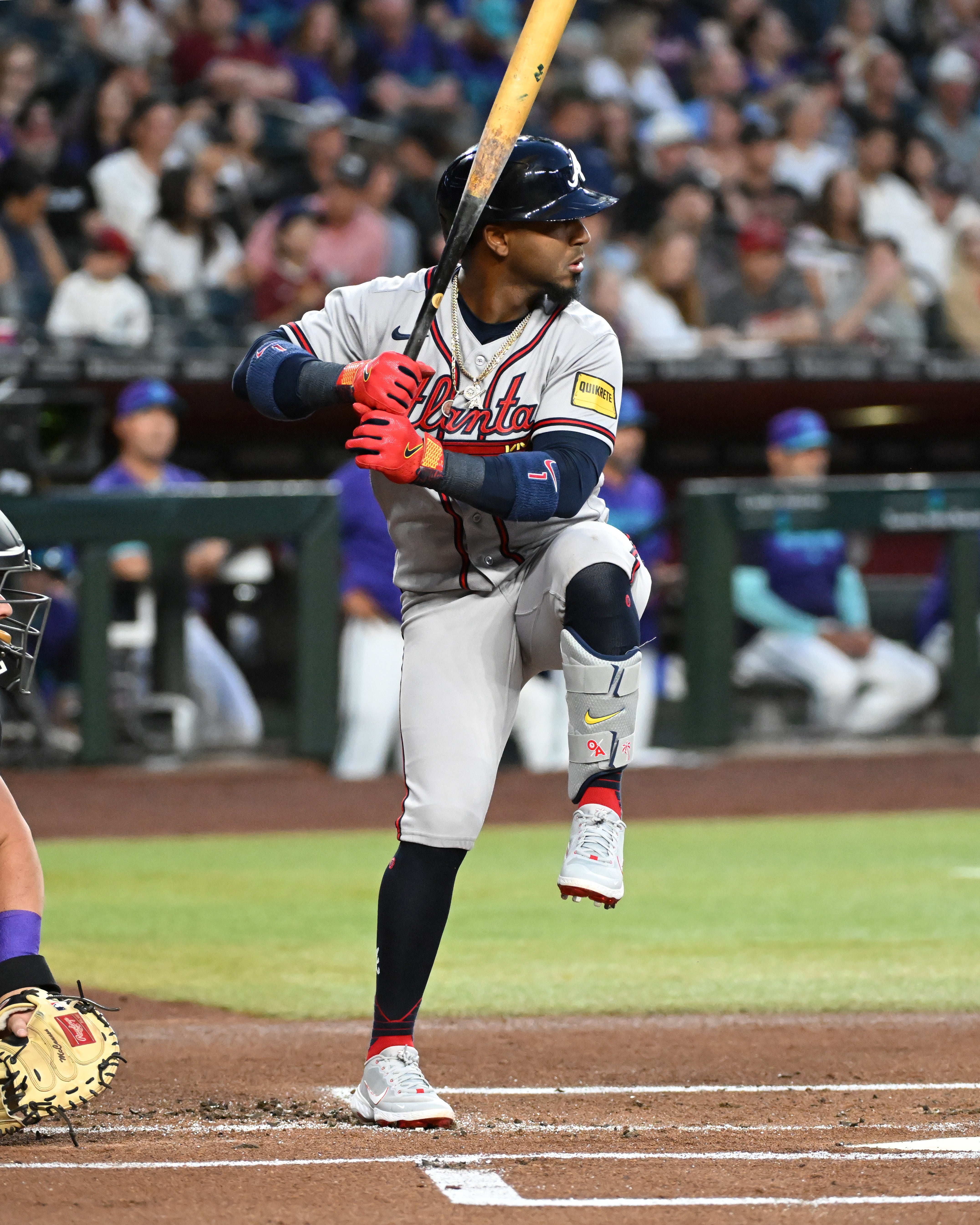 Baseball subordinate    successful  a batting stance, wearing a jersey and helmet, playing successful  a packed stadium