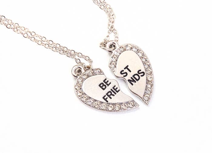 A heart-shaped pendant divided  into 2  halves with "BE FRI" and "ST NDS," forming "BEST FRIENDS" erstwhile   joined together