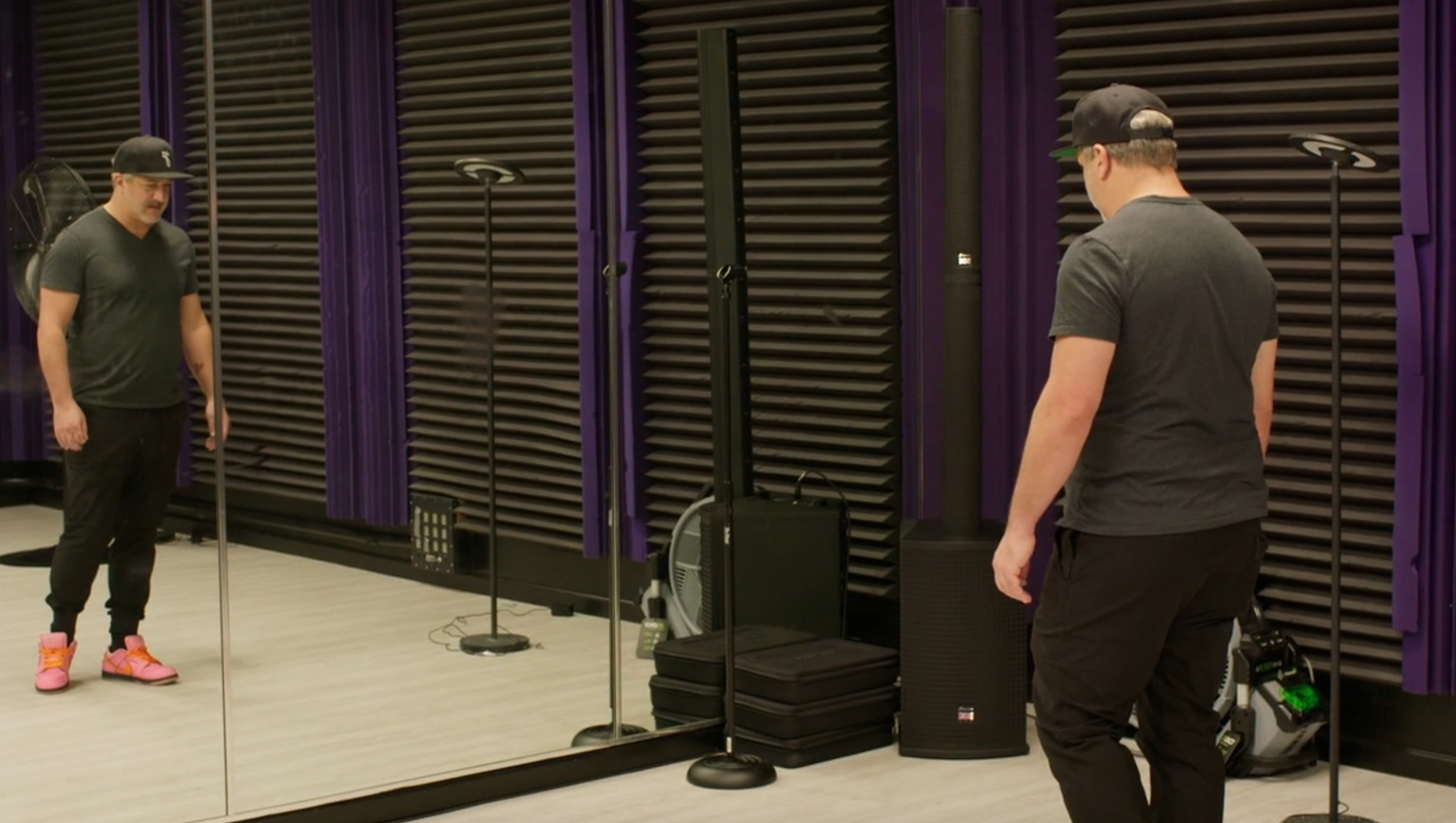 Person successful casual deterioration and headdress stands successful beforehand of mirrors successful a creation studio