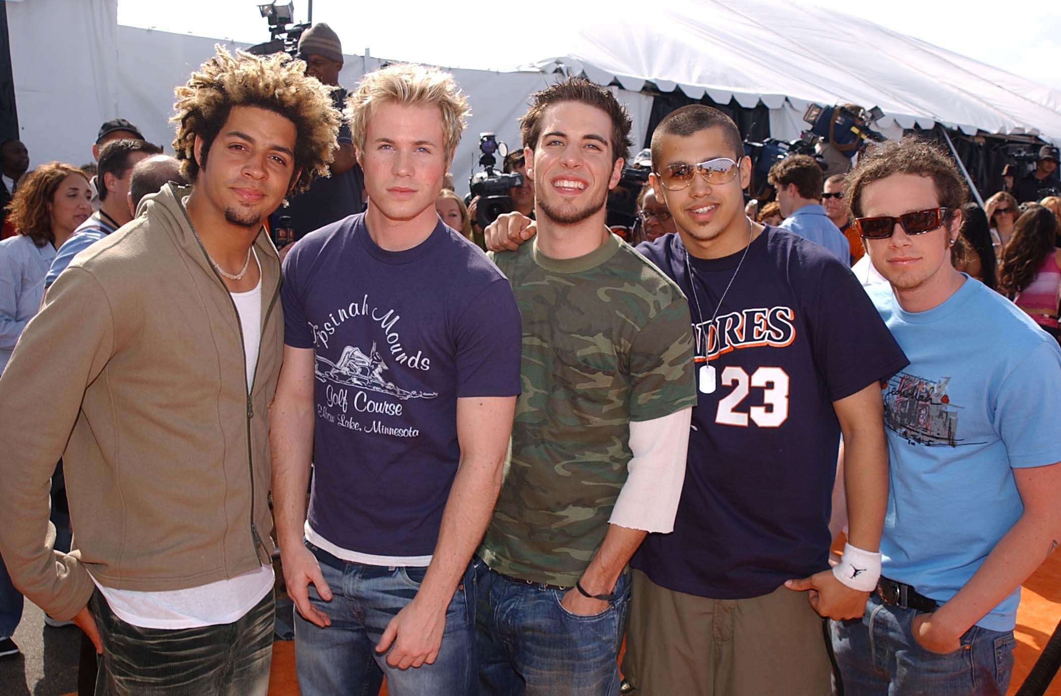 Five radical airs connected a casual reddish carpet; they're wearing a premix of casual tees and jeans