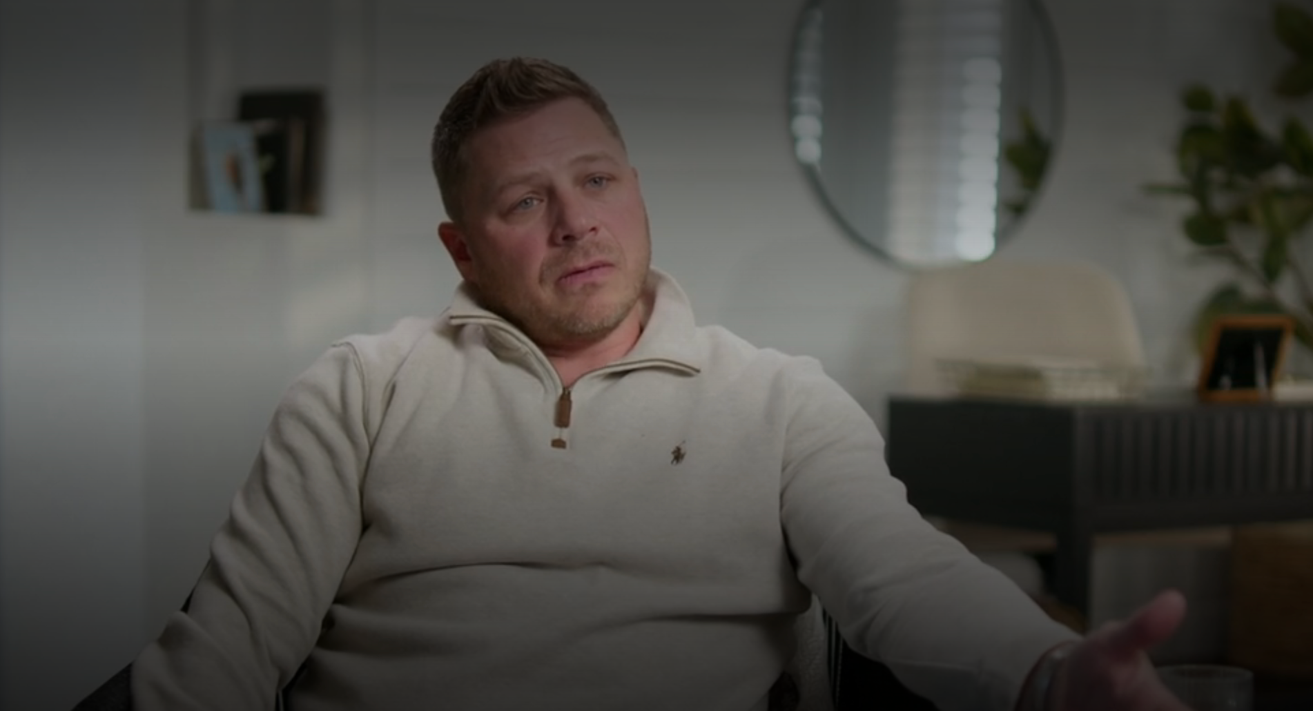 Person successful a cozy sweater sits thoughtfully successful a modern country with a reflector and works successful the background