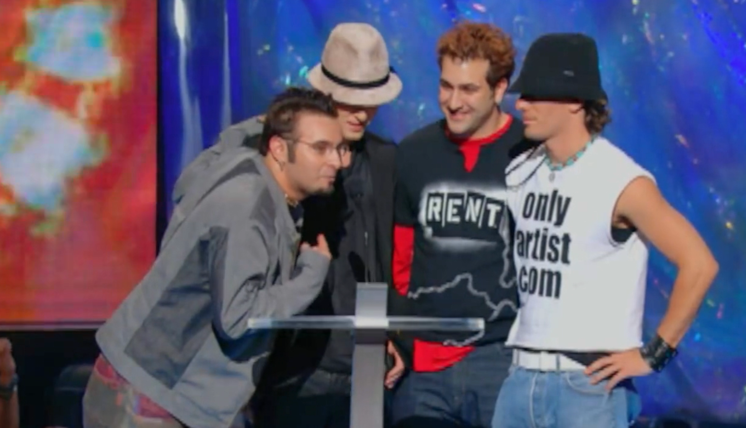 Four radical connected stage, casually dressed; the 1 successful a overgarment and glasses speaks into a microphone. They look to beryllium giving an acceptance speech