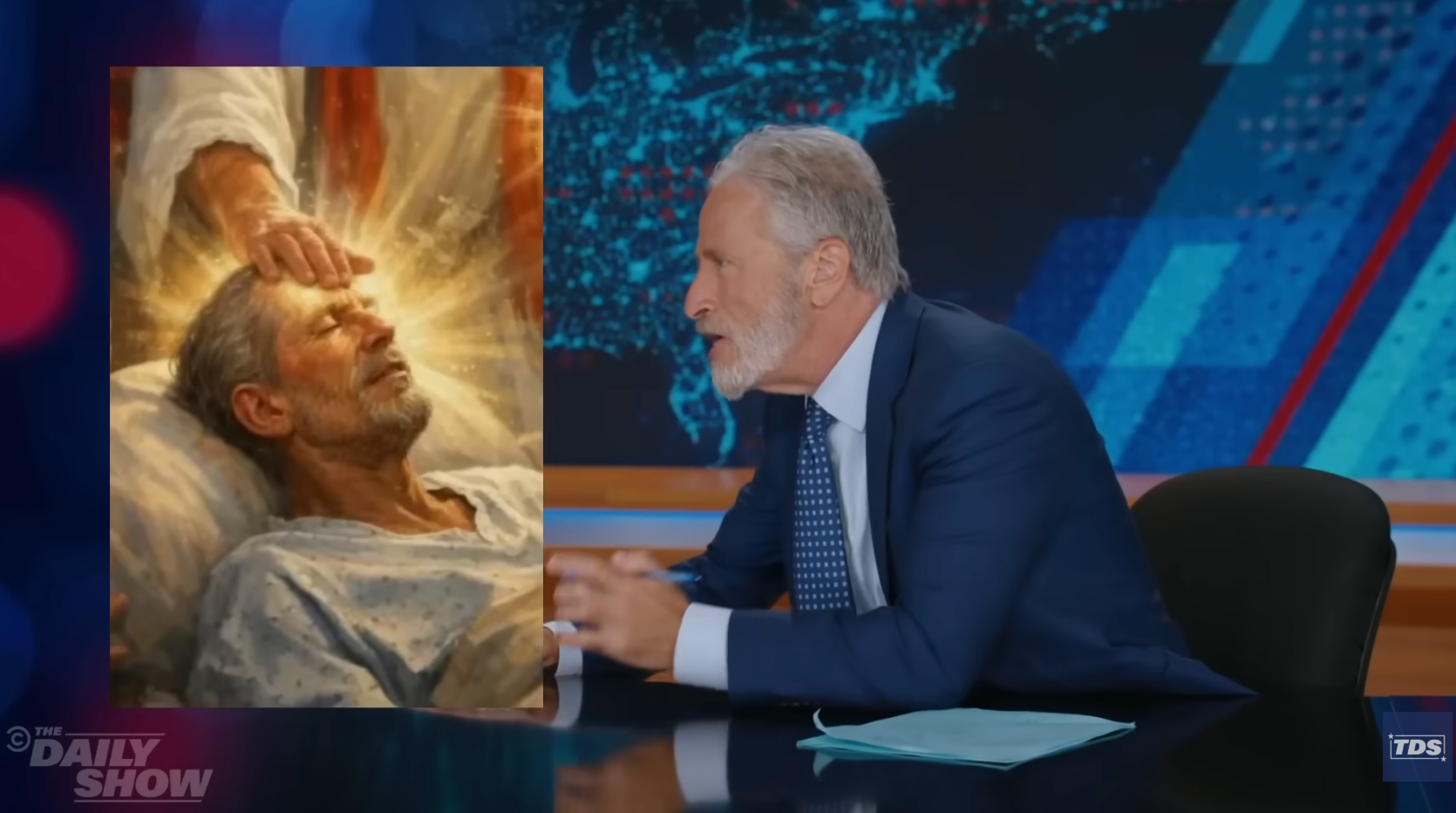 A antheral successful a suit humorously reacts to a coating of a man's caput being touched with a glowing manus connected a speech amusement set