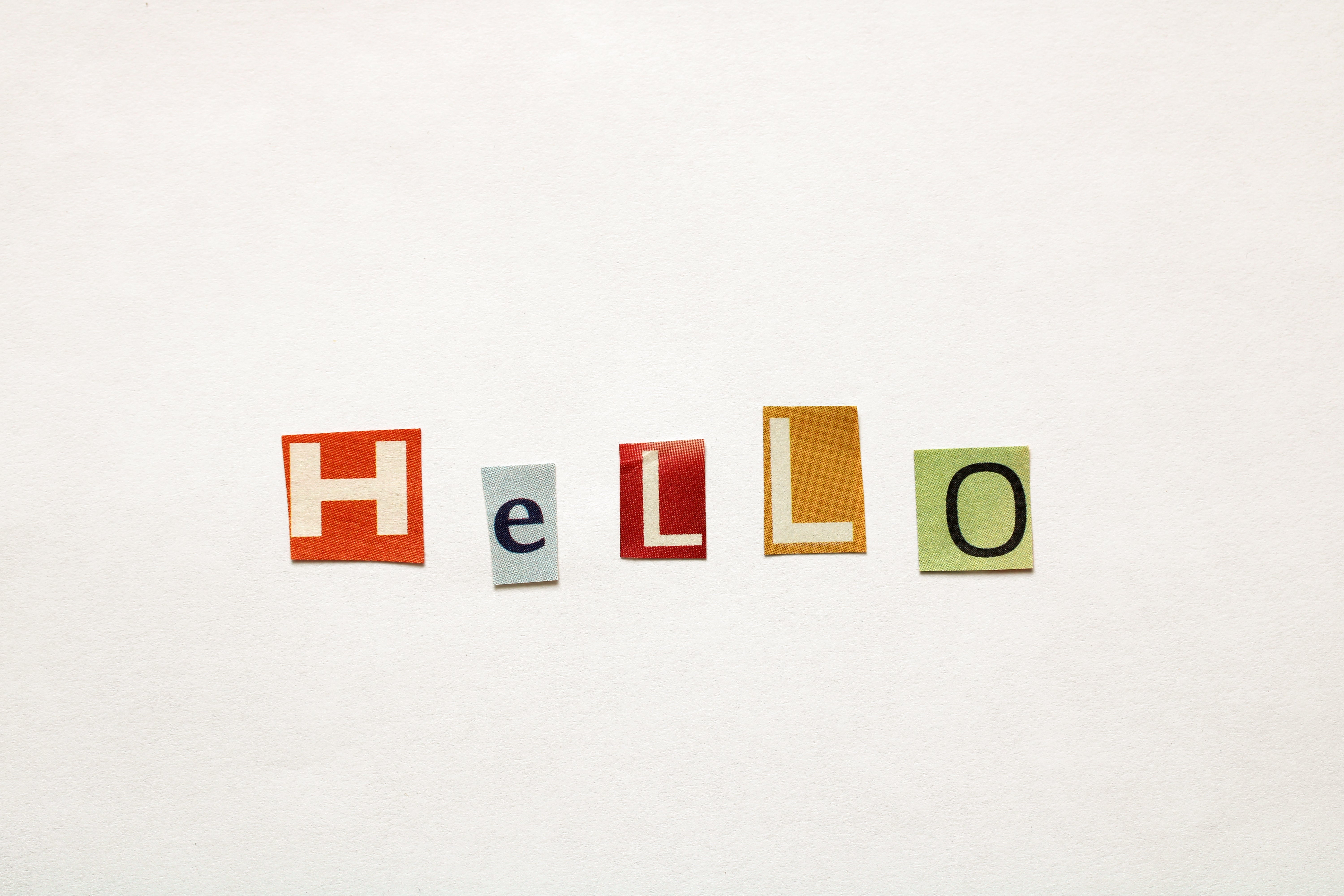 Letters cut from magazines spell "HELLO" on a plain background