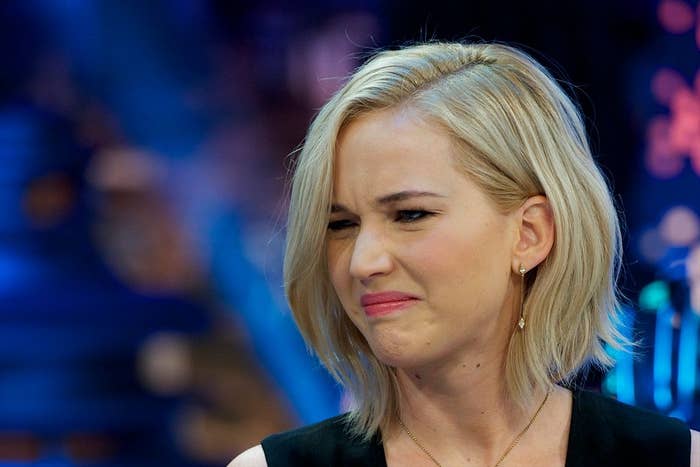 Person making a displeased look  during an interview. They person  short, styled hairsbreadth  and are wearing a sleeveless apical  with elemental  earrings