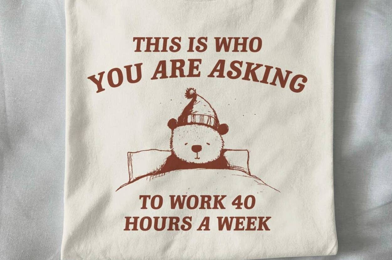 T-shirt with a bear and text: "This is who you are asking to work 40 hours a week." Next to it, a bouquet of knitted flowers on a table