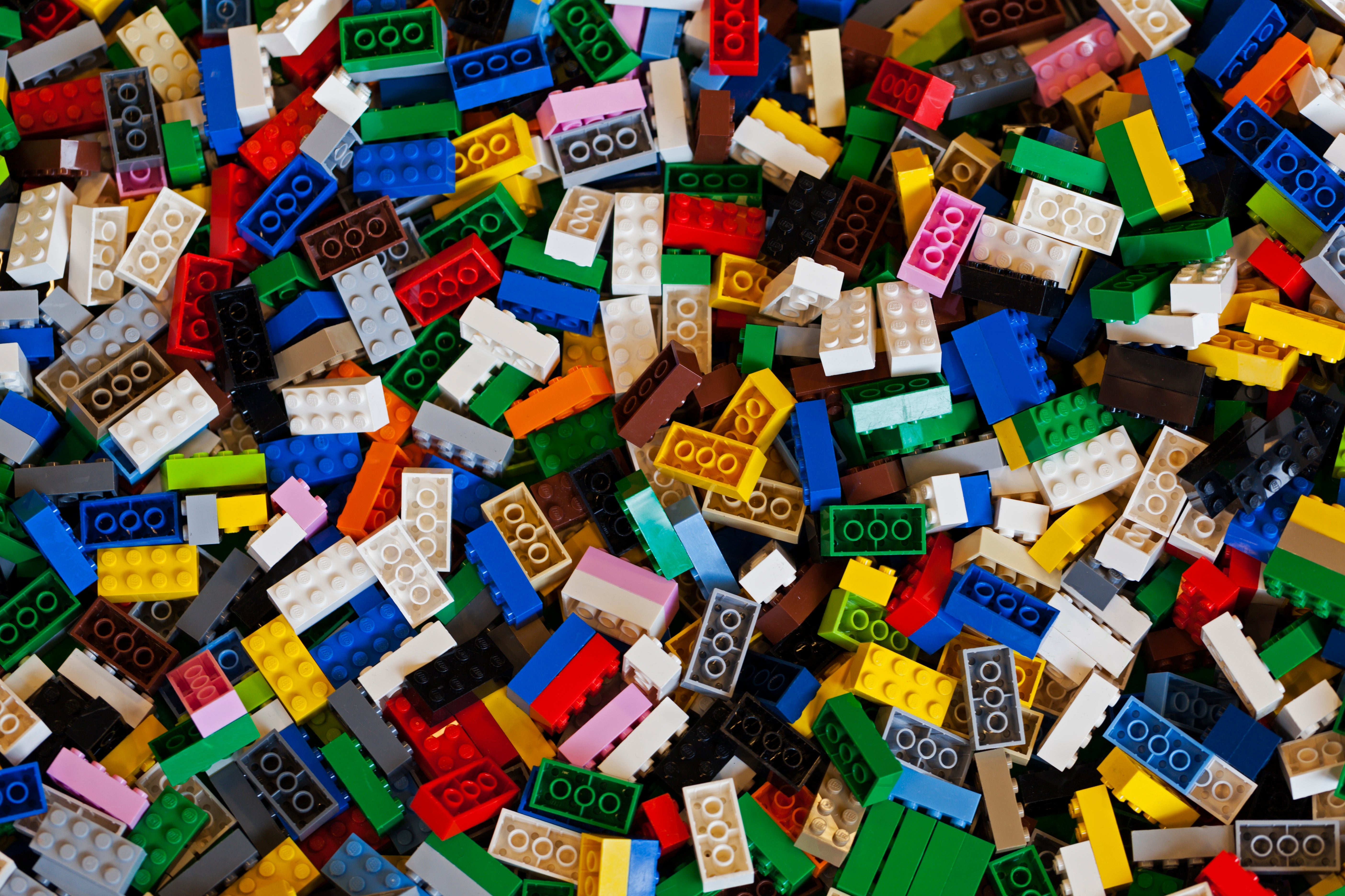 A ample  heap  of variously shaped and sized Lego bricks scattered randomly