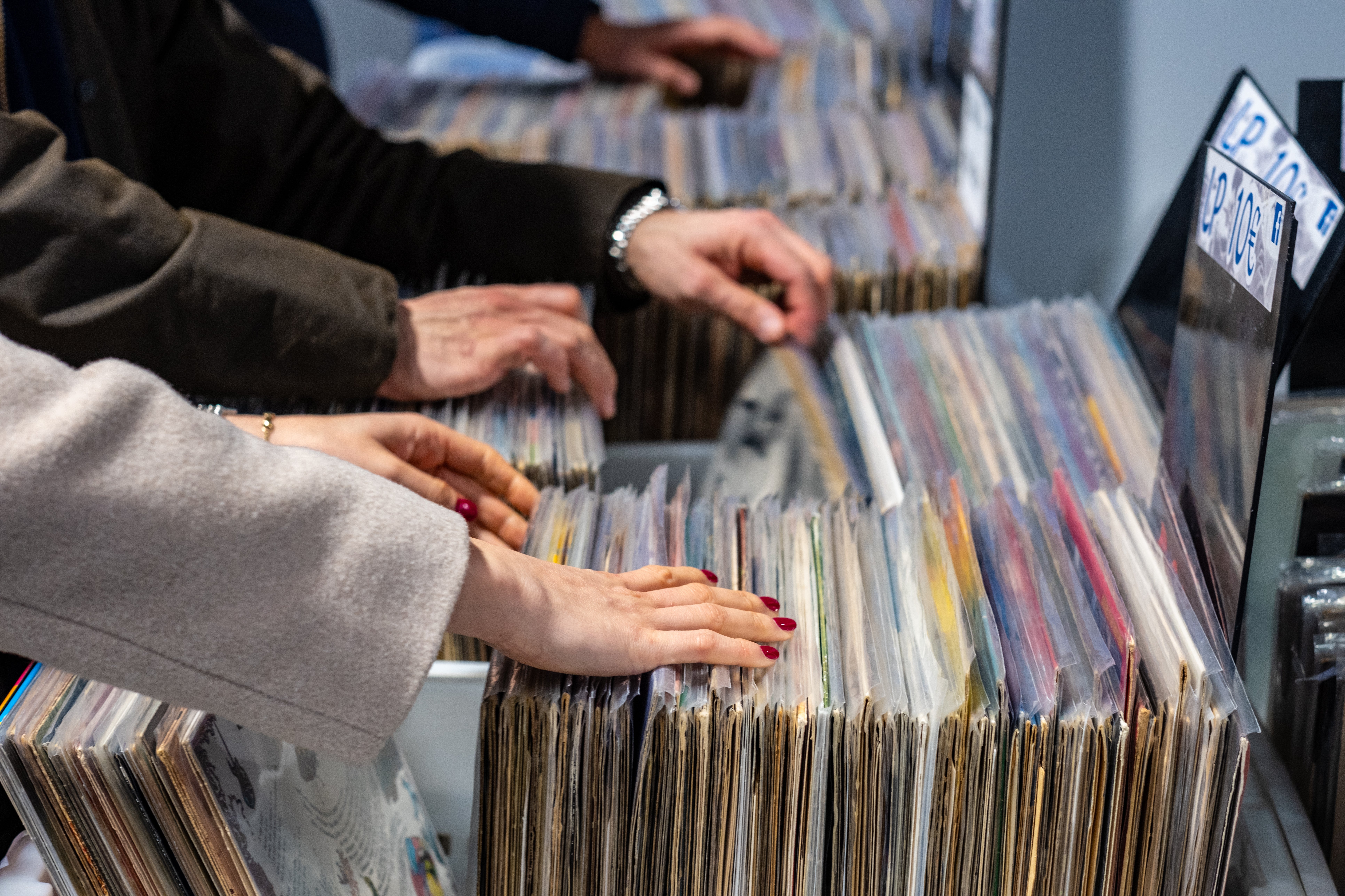 People flipping done  vinyl records successful  a store