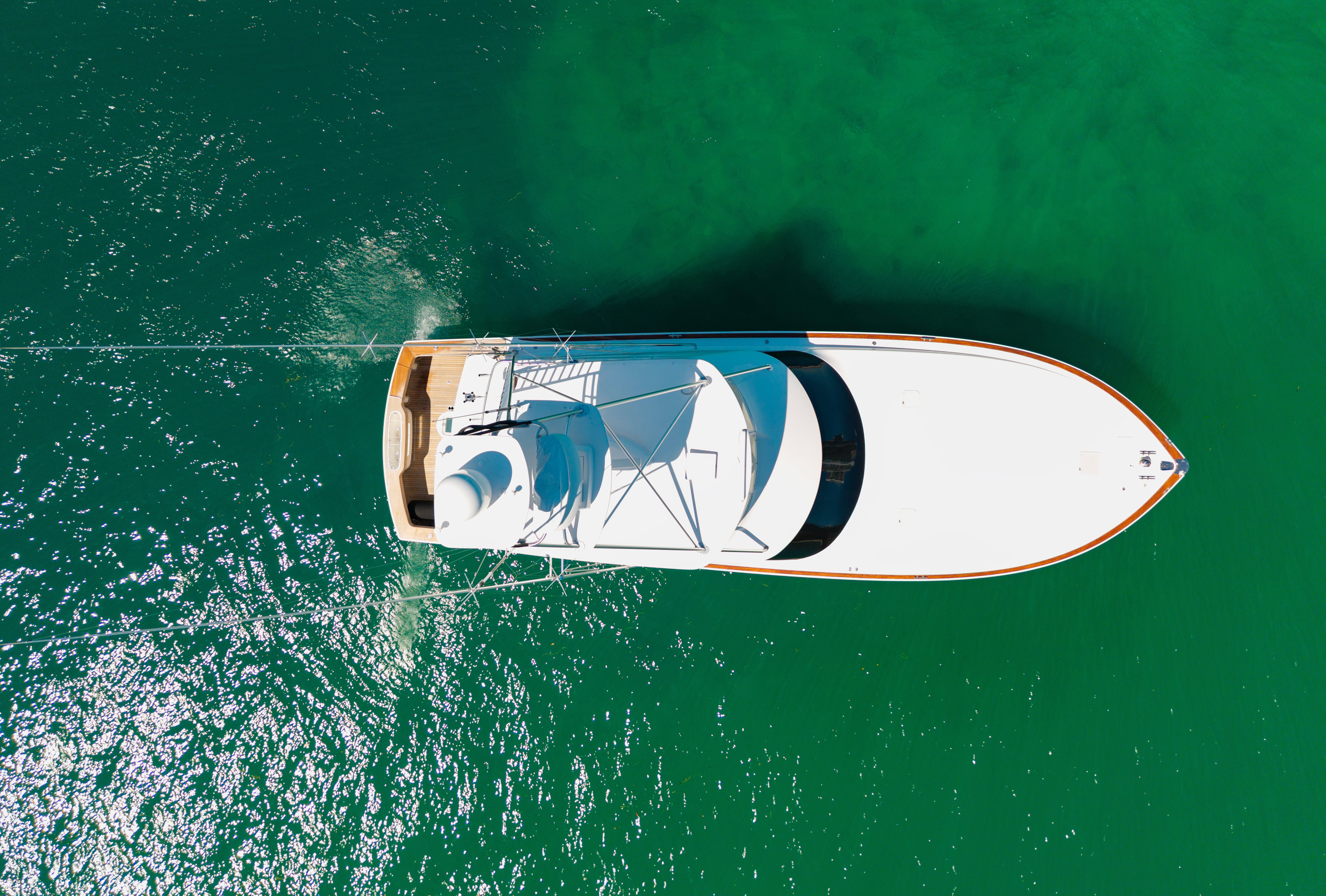 Aerial presumption    of a achromatic  yacht sailing connected  a calm, greenish assemblage  of water