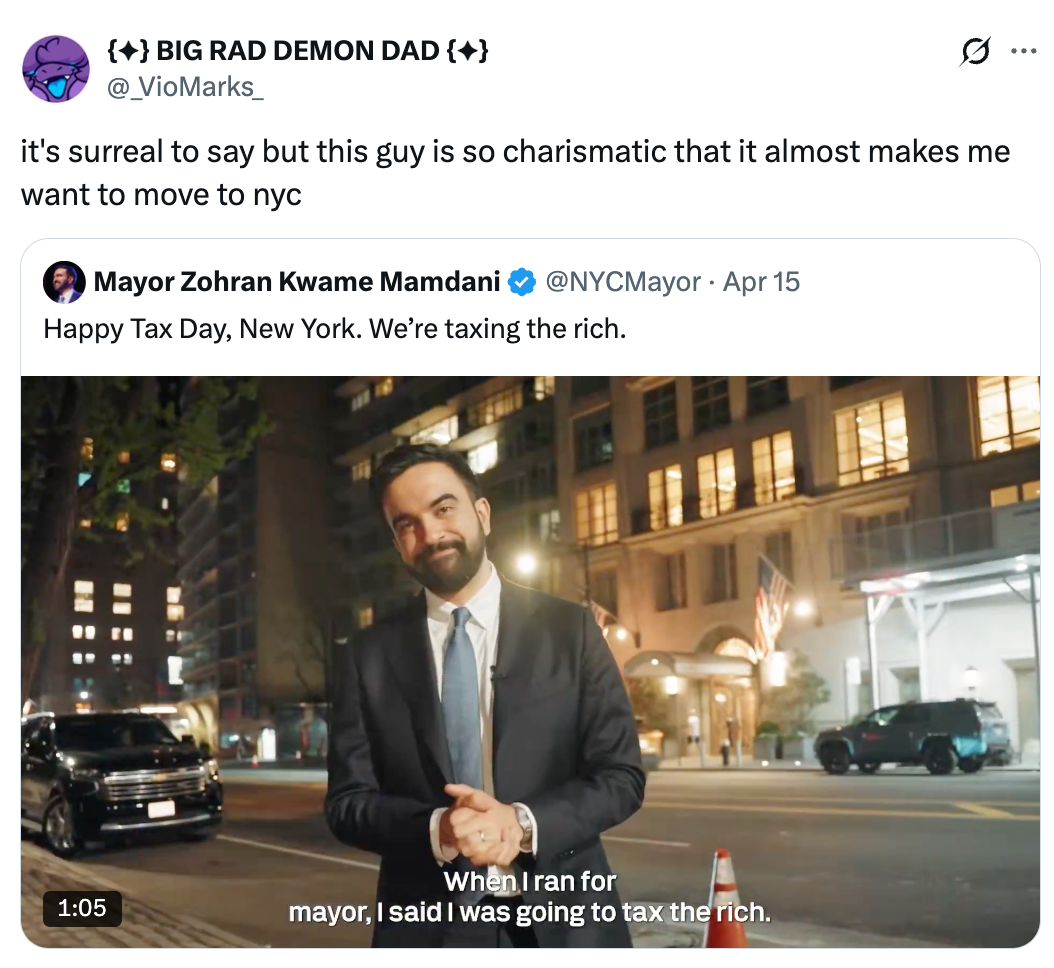 A antheral   successful  a suit   stands smiling connected  a metropolis  street, with substance   stating committedness  to taxing the rich