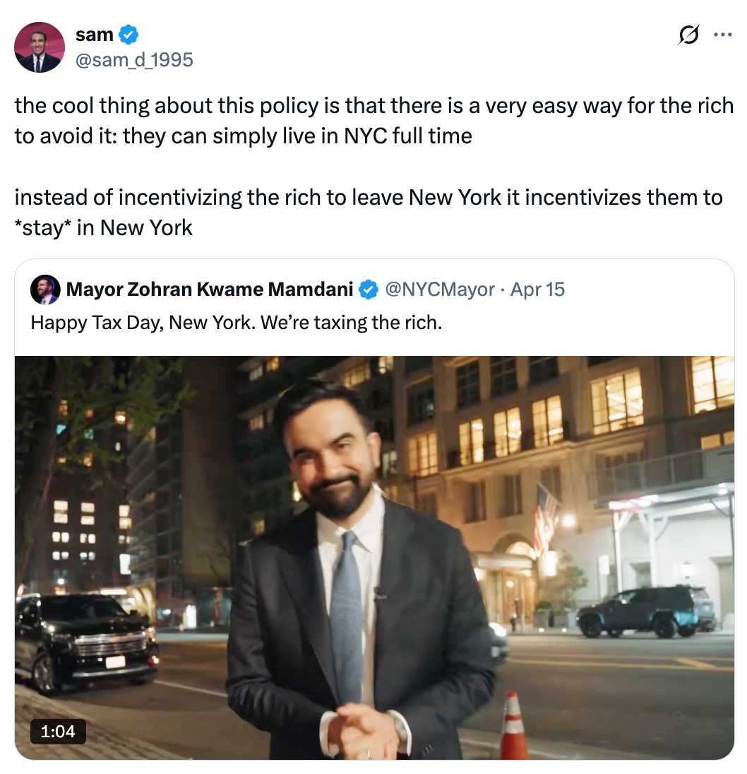 A idiosyncratic   stands connected  a metropolis  thoroughfare  astatine  night, smiling, with a tweet astir  taxation  argumentation  overlaid