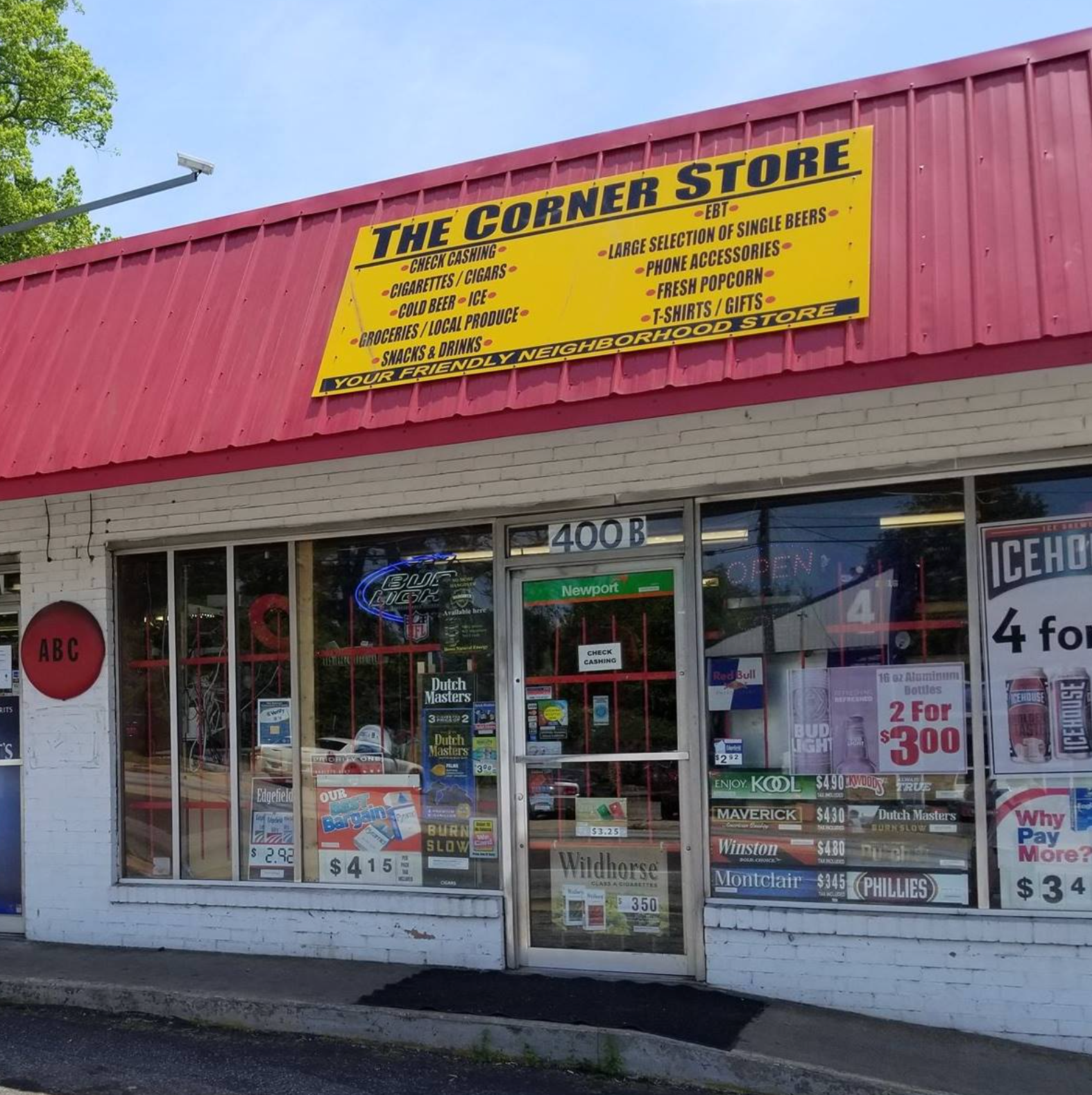 The representation  shows the exterior of "The Corner Store," with signs for snacks, beer, tobacco, and convenience items