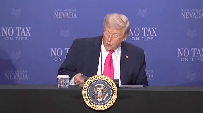 A idiosyncratic   speaking astatine  a array  with a "President of the United States" emblem, against a "No Tax connected  Tips" backdrop