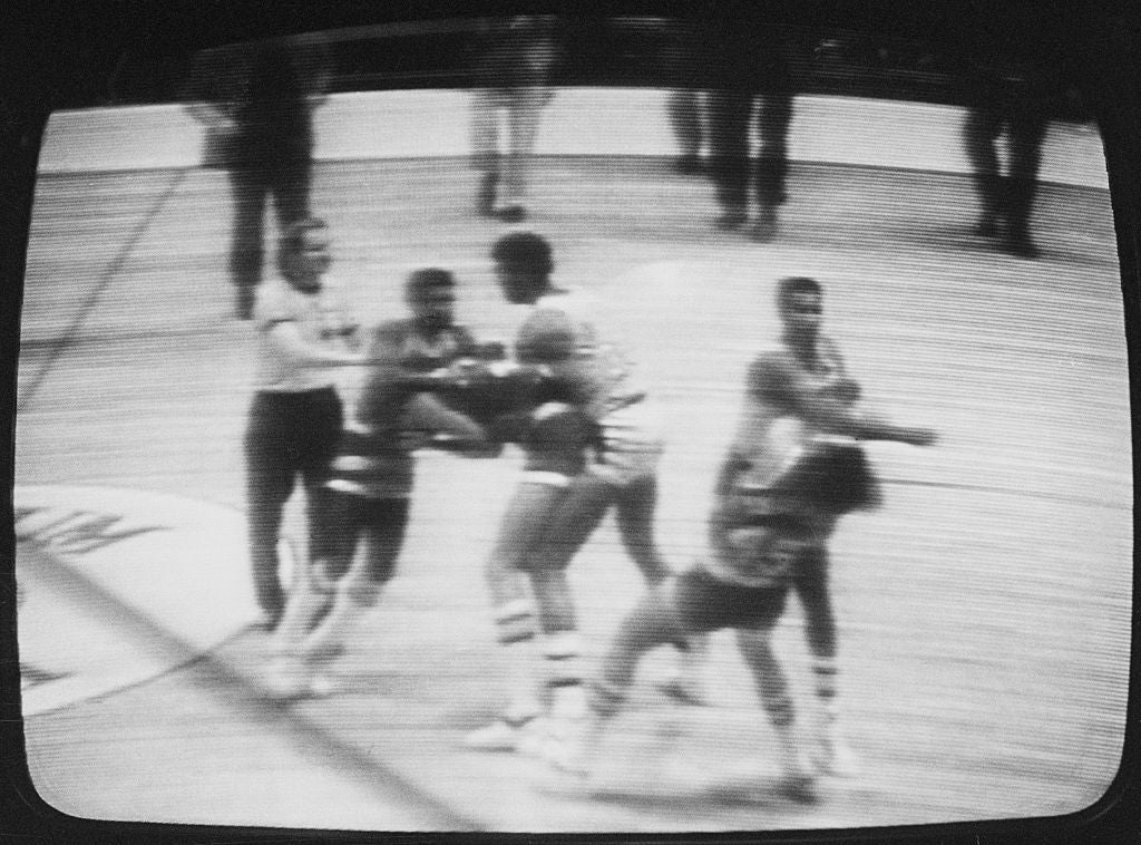 Vintage black-and-white photograph  of a hoops  game; players and officials look  to beryllium  successful  a quality   oregon  altercation connected  the court