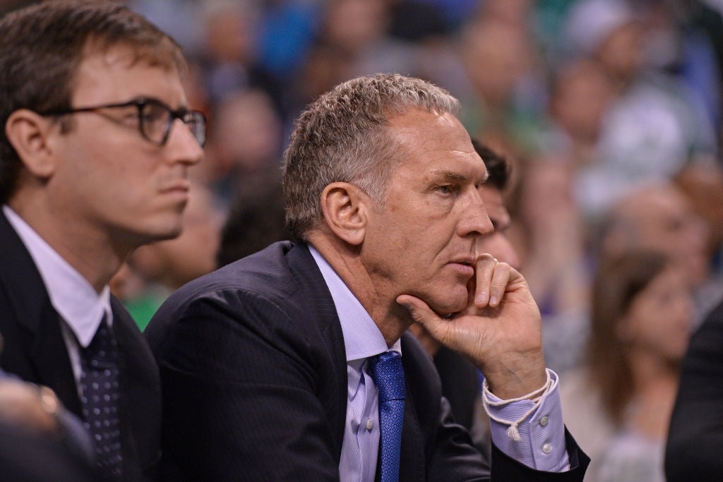 Two men successful  suits attentively ticker  a hoops  crippled  from the sidelines