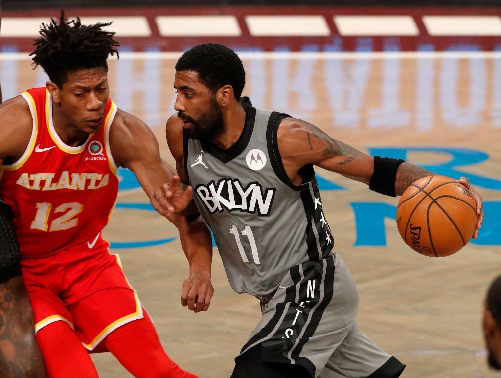 Two hoops  players successful  enactment   during a game; 1  dribbling the shot  portion    the different   defends closely