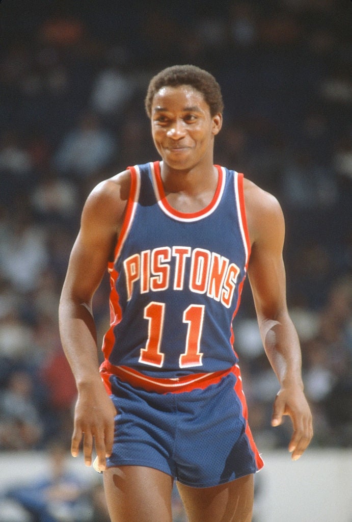 Basketball subordinate    successful  a Pistons jersey, fig   11, during a game, smiling and walking connected  the court