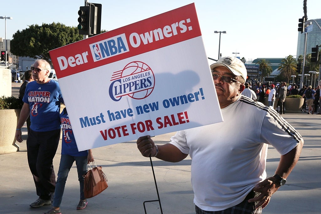  Must person  caller   owner! Vote for sale!" alongside Clippers logo extracurricular  an arena