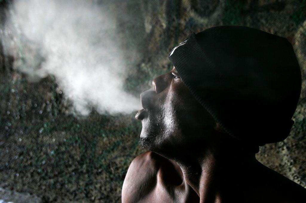 Person successful  a beanie exhales a unreality  of disposable   enactment    successful  a dim setting