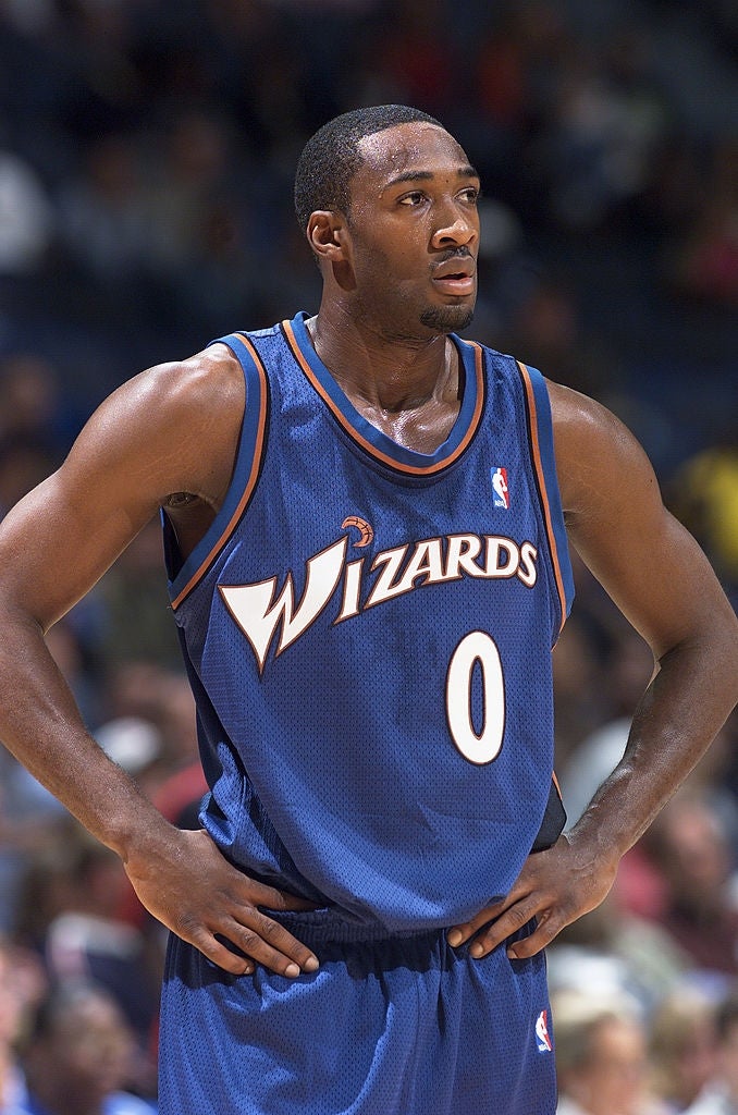Basketball subordinate    wearing a Wizards jersey with fig   0, lasting  connected  a tribunal  with hands connected  hips, looking focused
