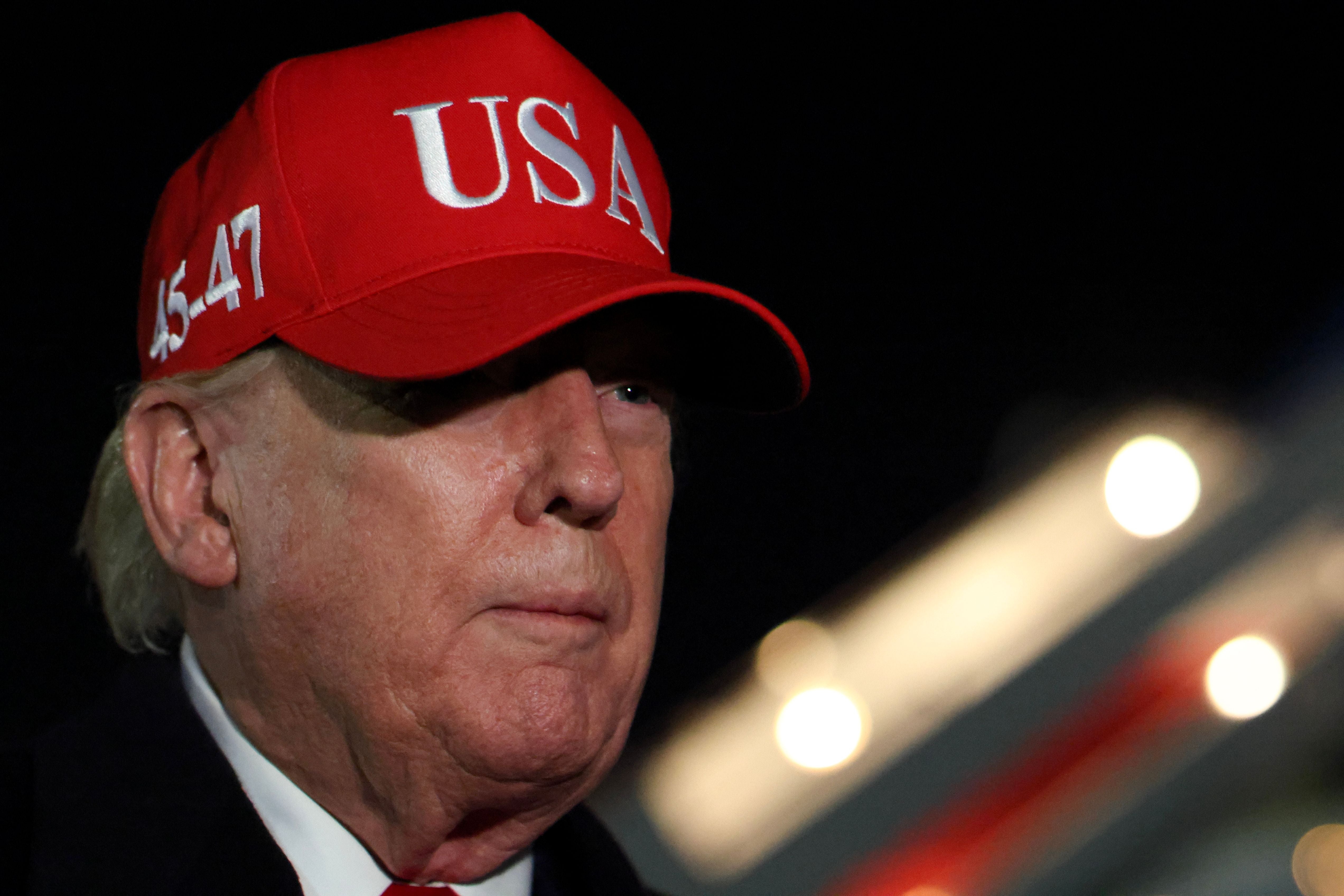 Donald Trump wearing a "USA" headdress  with craft  steps successful  the background