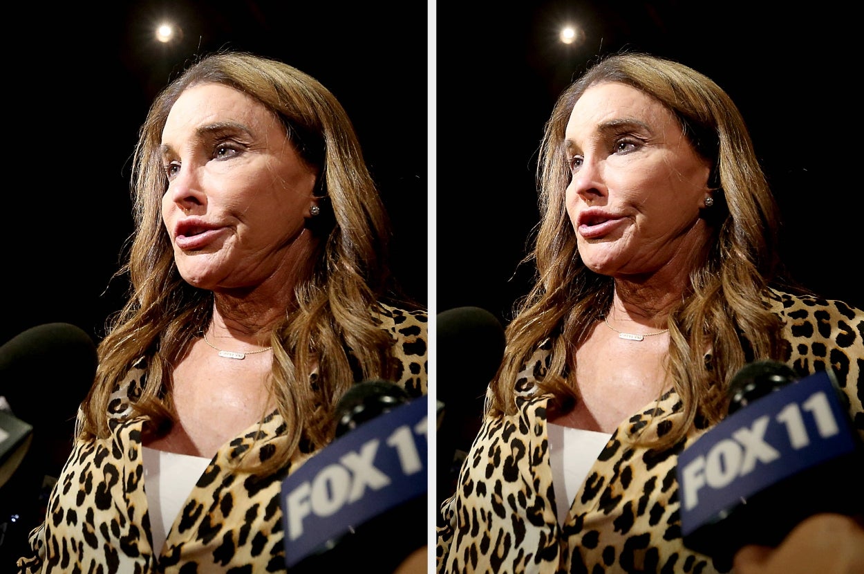 Caitlyn Jenner with long hair wearing animal print clothing, speaking to microphones at a media event