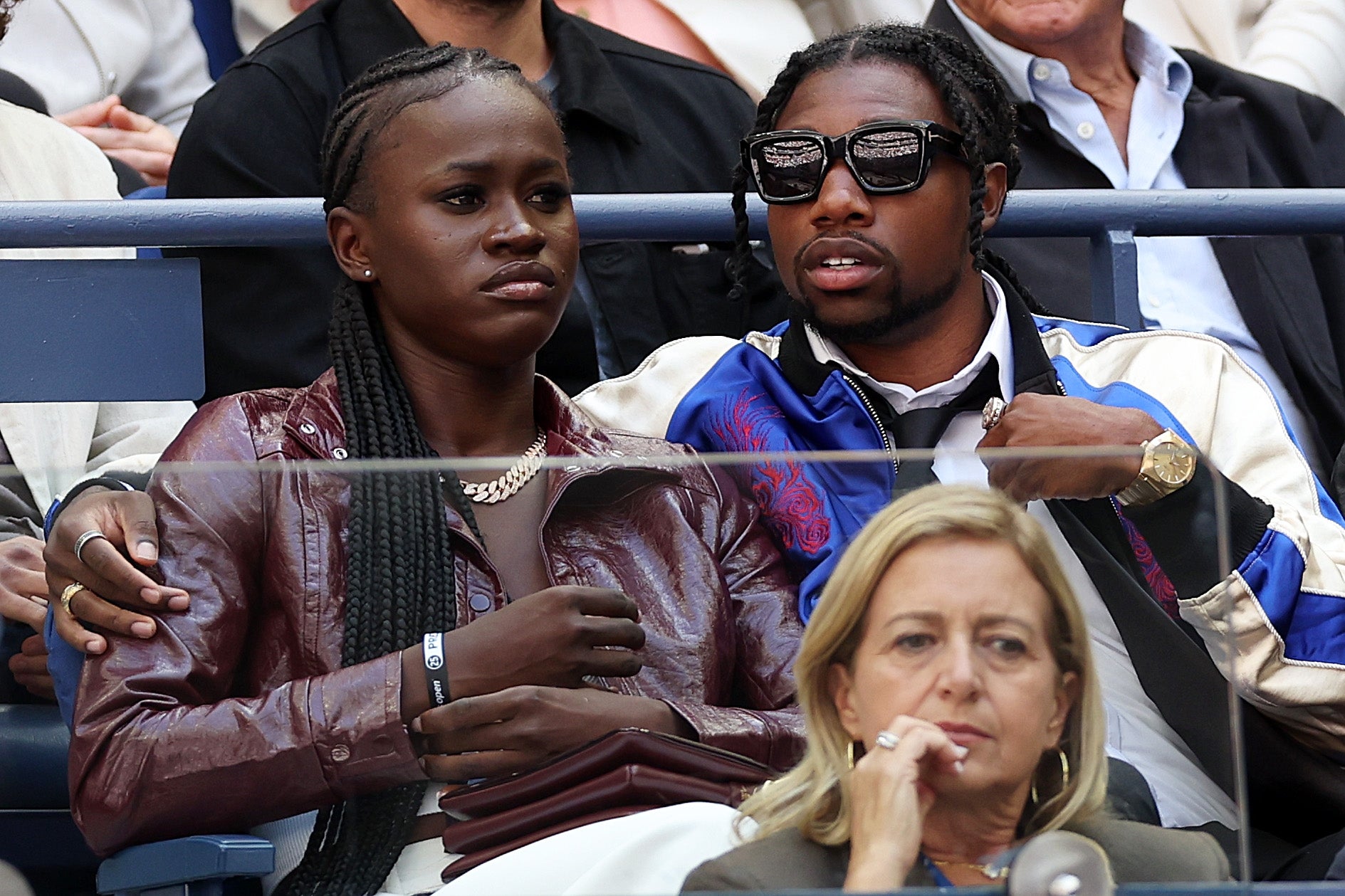 Two radical   beryllium   adjacent  unneurotic  astatine  an event. One wears a connection    overgarment   and sunglasses, the different   dons a sleek jacket. They look  engaged with the event