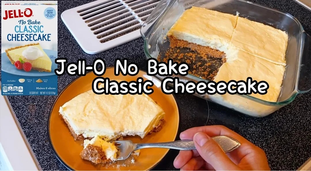 Jell-O No Bake Classic Cheesecake box beside a baking dish and a served slice on a plate with a hand holding a fork