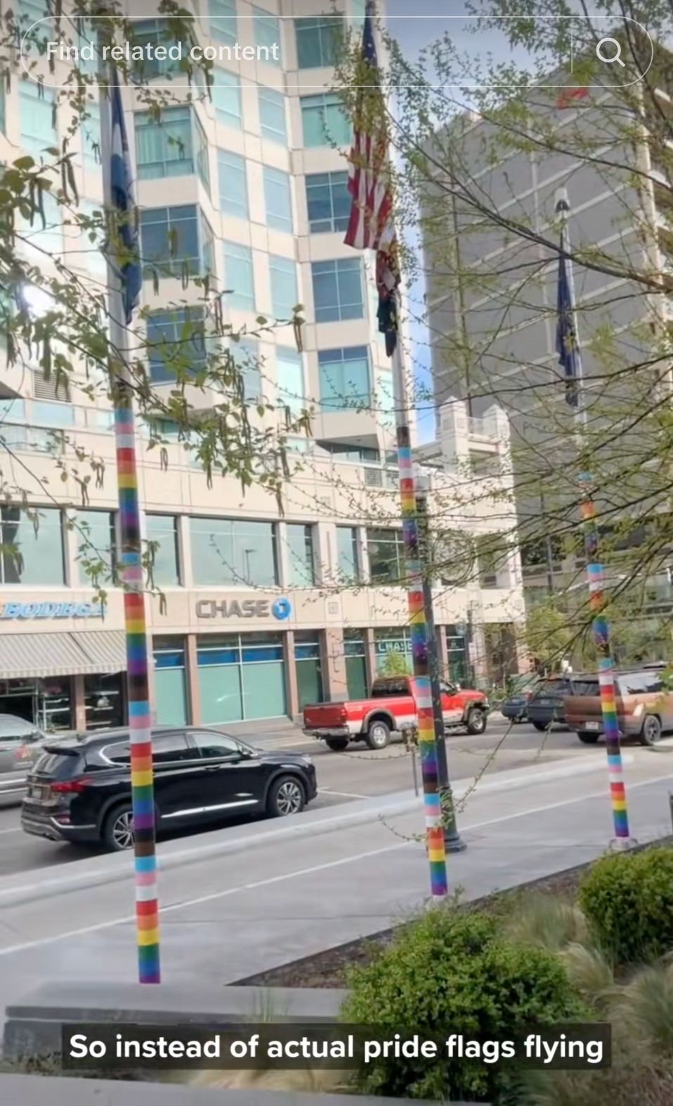 Street with rainbow-striped poles and a gathering  backdrop; substance   reads, "So alternatively  of existent  pridefulness  flags flying."