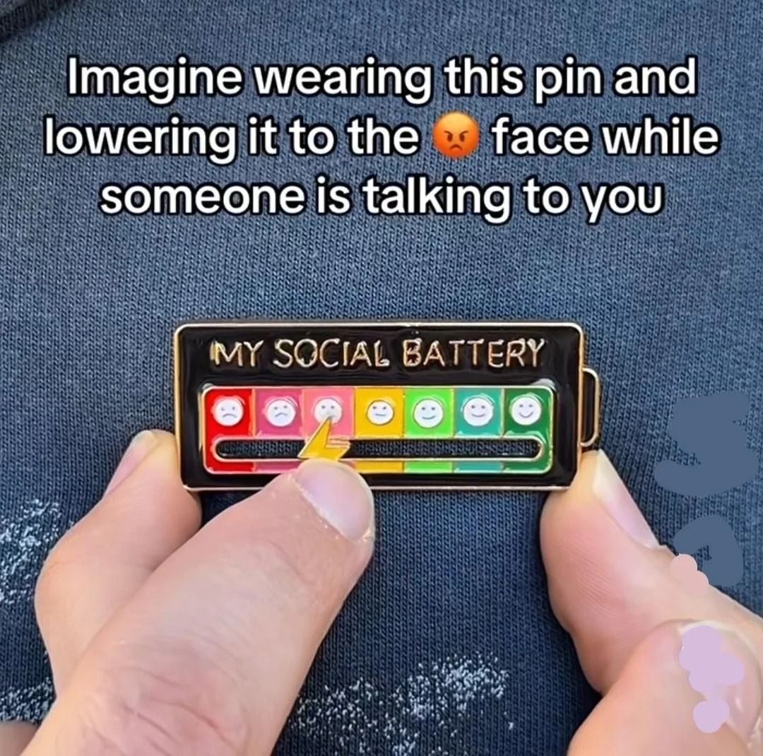 Humorous pin with a social battery scale from happy to angry. Text: "Imagine wearing this pin and lowering it to the angry face while someone is talking to you."