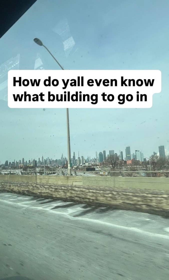 A city skyline view with a text overlay that reads, "How do yall even know what building to go in."