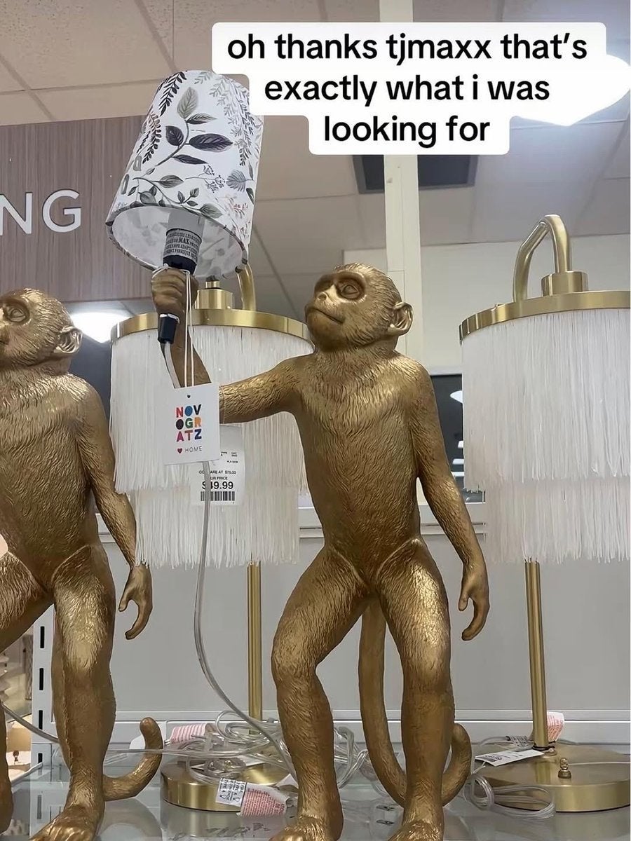 Display of monkey-shaped lamp bases holding lampshades with price tags in a store. Text above reads, "oh thanks tjmaxx that's exactly what i was looking for."