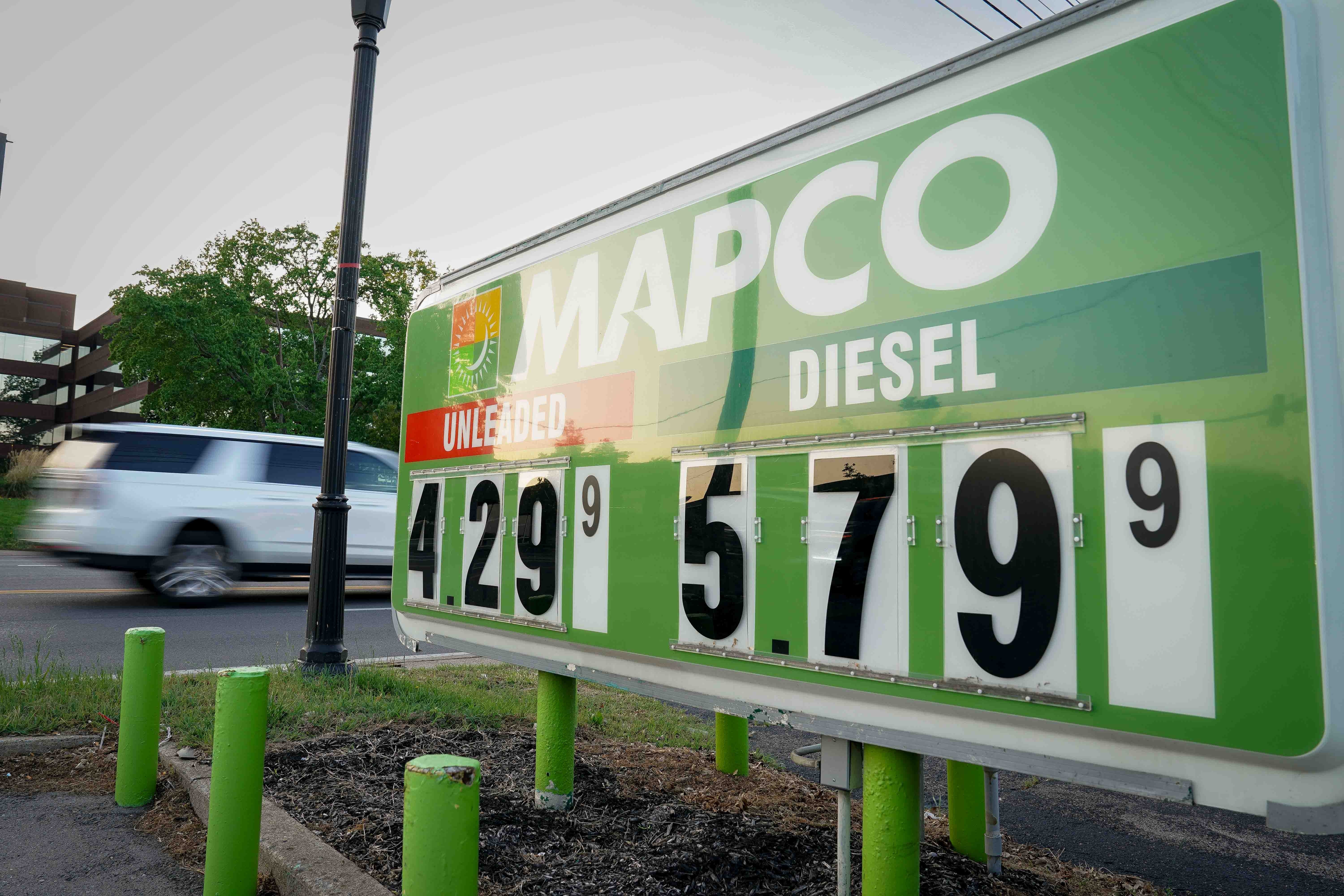  unleaded astatine  $4.29 and diesel astatine  $5.79. A car   passes by successful  the background