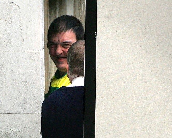 Person smiling portion    partially disposable   down  a door, dressed casually