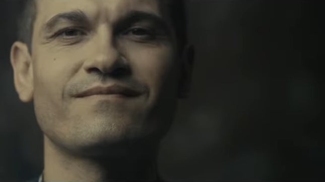 Smiling idiosyncratic   looking straight  astatine  the camera successful  a close-up shot