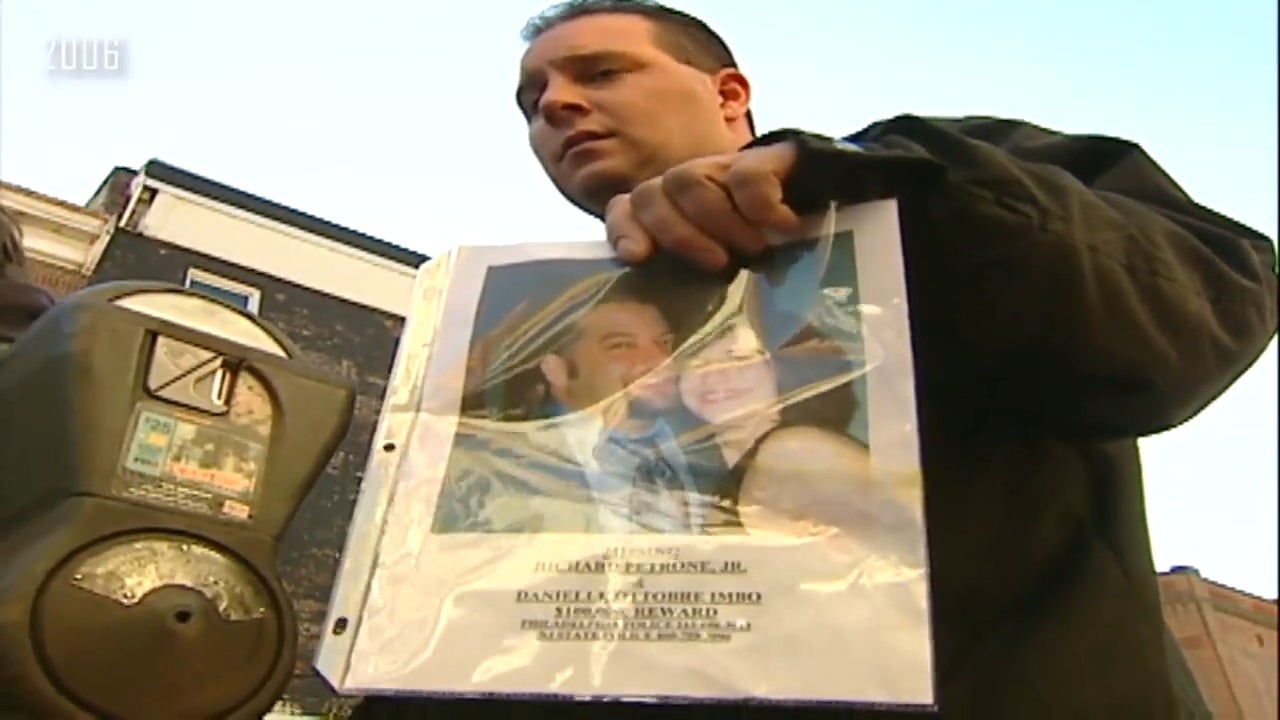 A idiosyncratic   holds a plastic-covered photograph  of a couple, lasting  adjacent   a parking meter, perchance  advocating oregon  sharing a message