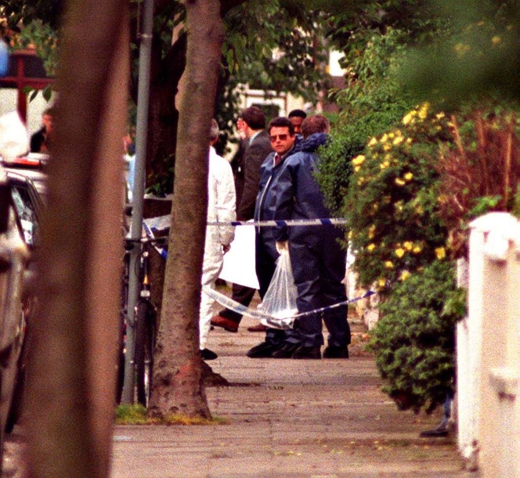 A radical  of investigators successful  protective covering  enactment    astatine  a cordoned-off country  connected  a residential street