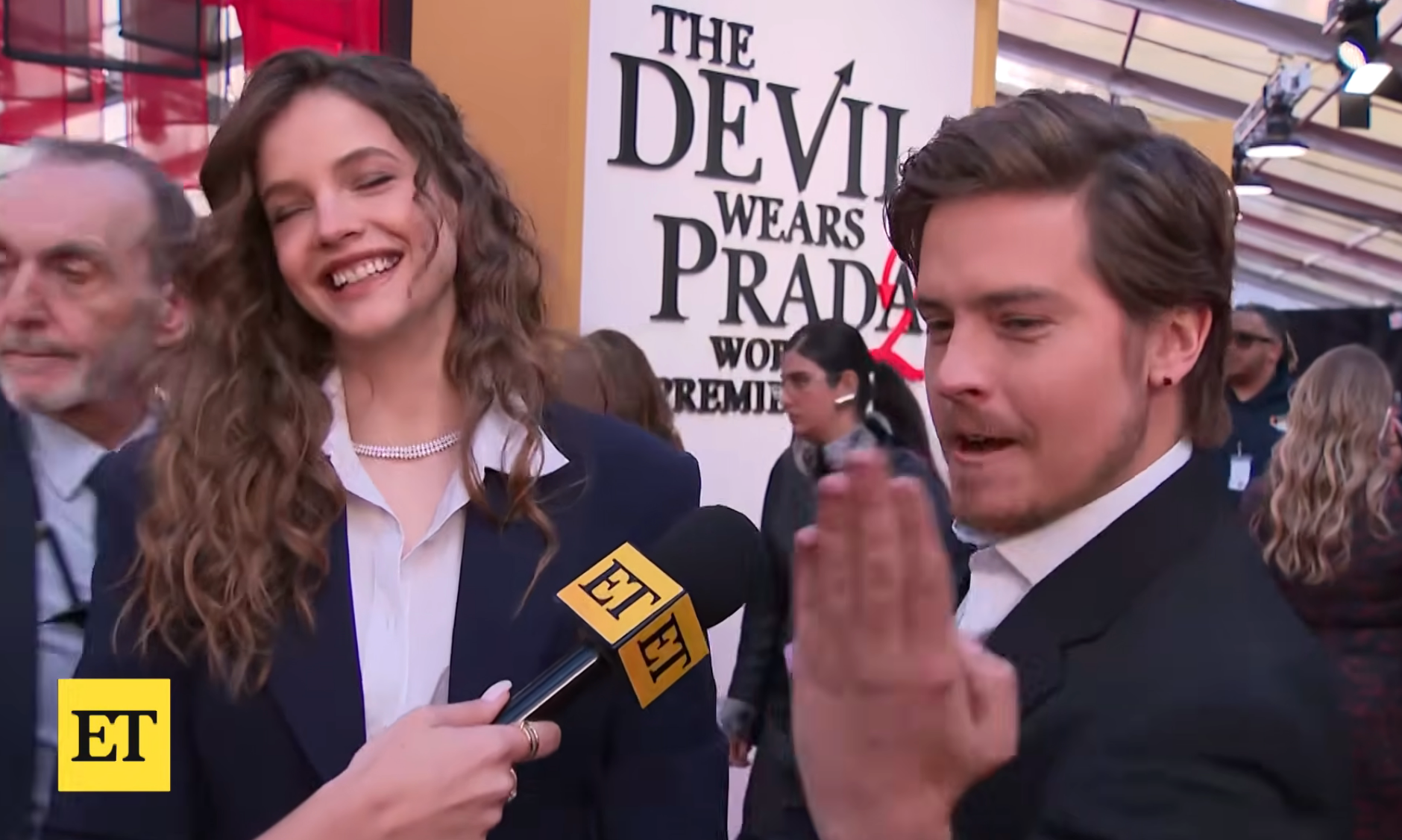 Two radical   are being interviewed astatine  a "The Devil Wears Prada" event, smiling and gesturing