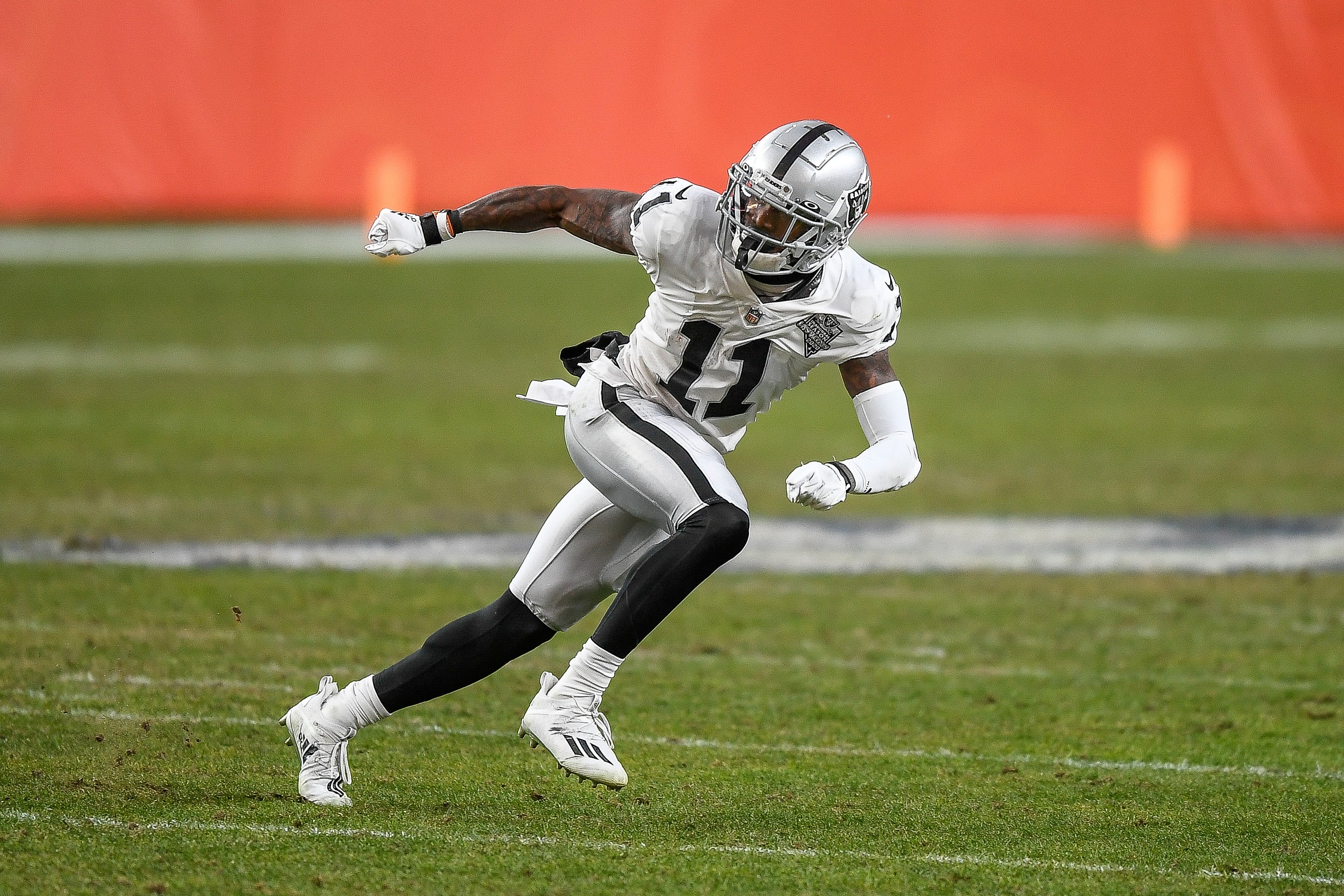 Football subordinate    successful  enactment   connected  the field, wearing a helmet and afloat  gear, moving  with absorption   during a game