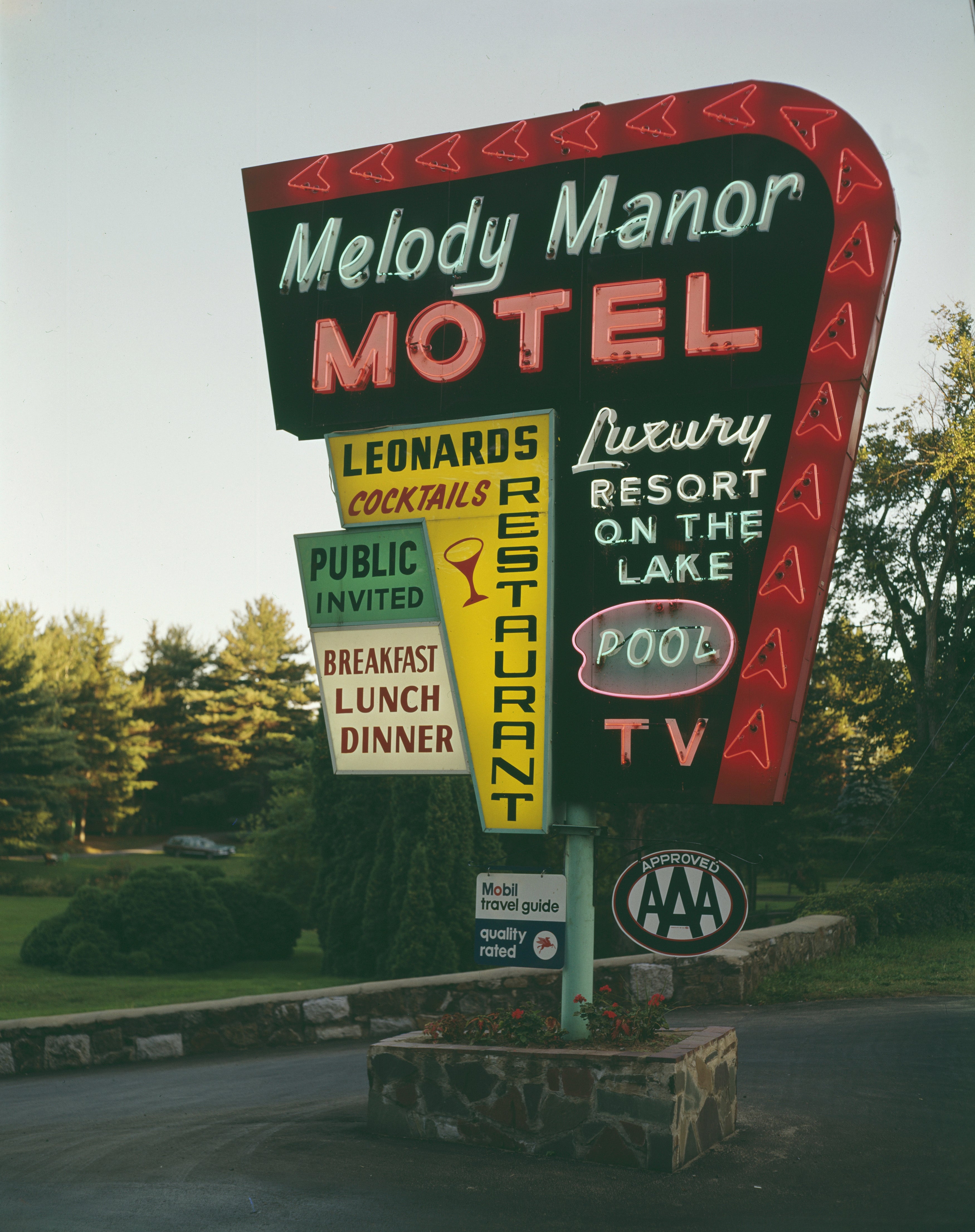 Retro roadside motion   for Melody Manor Motel, featuring amenities similar  restaurant, pool, TV, and AAA approval. Located adjacent   greenery; nationalist   invited