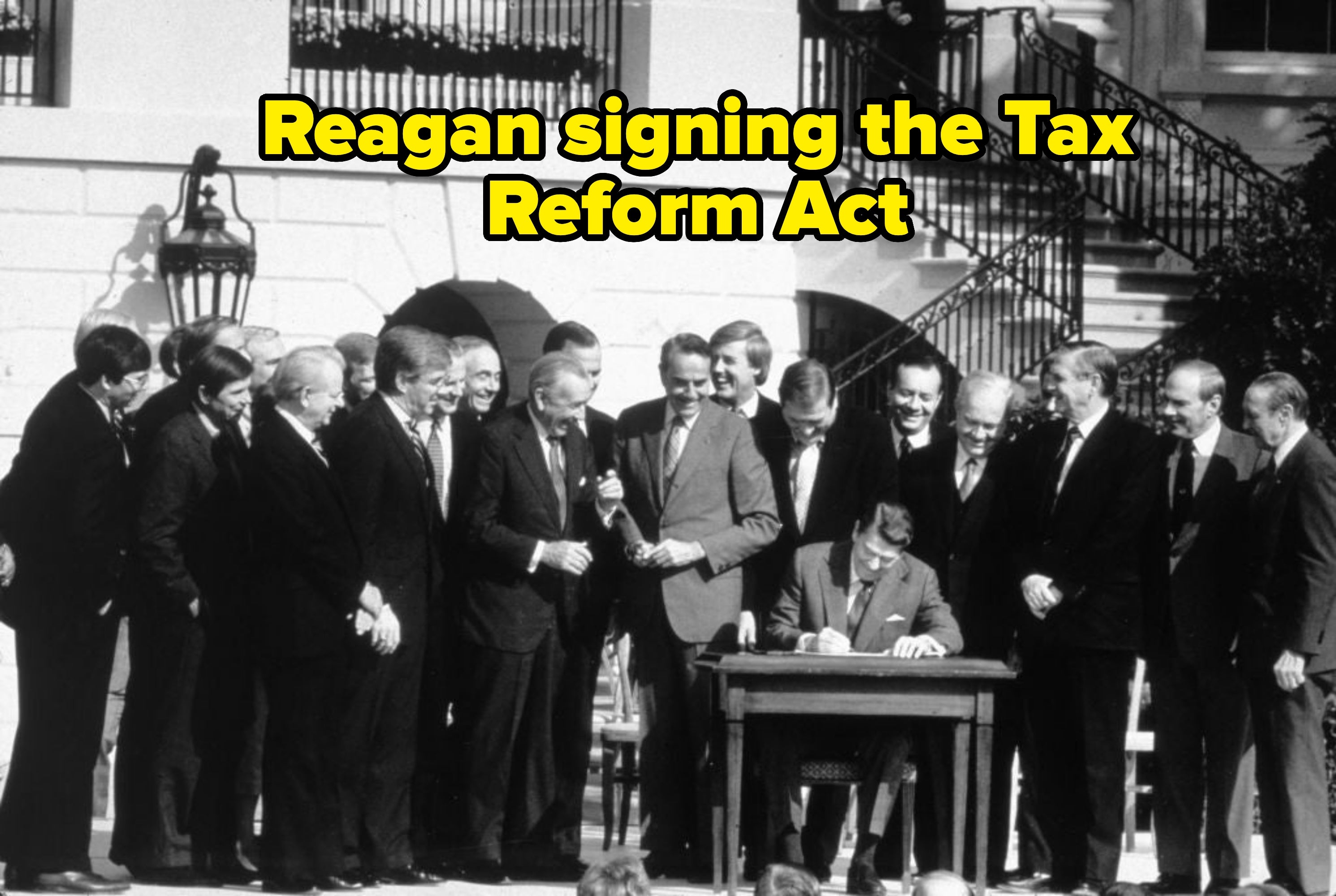 Group of men successful  suits situation   a idiosyncratic   seated astatine  a desk, signing a papers  outdoors