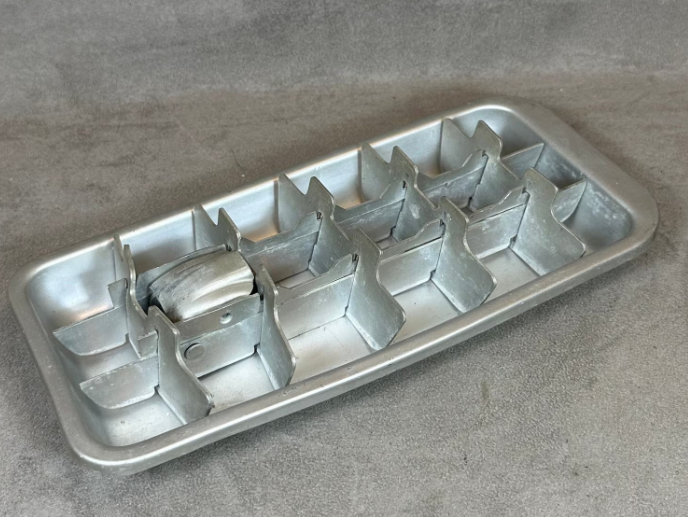 Metal crystal  cube tray with manual lever mechanism, utilized  for making crystal  cubes earlier  modern   integrative  trays became popular