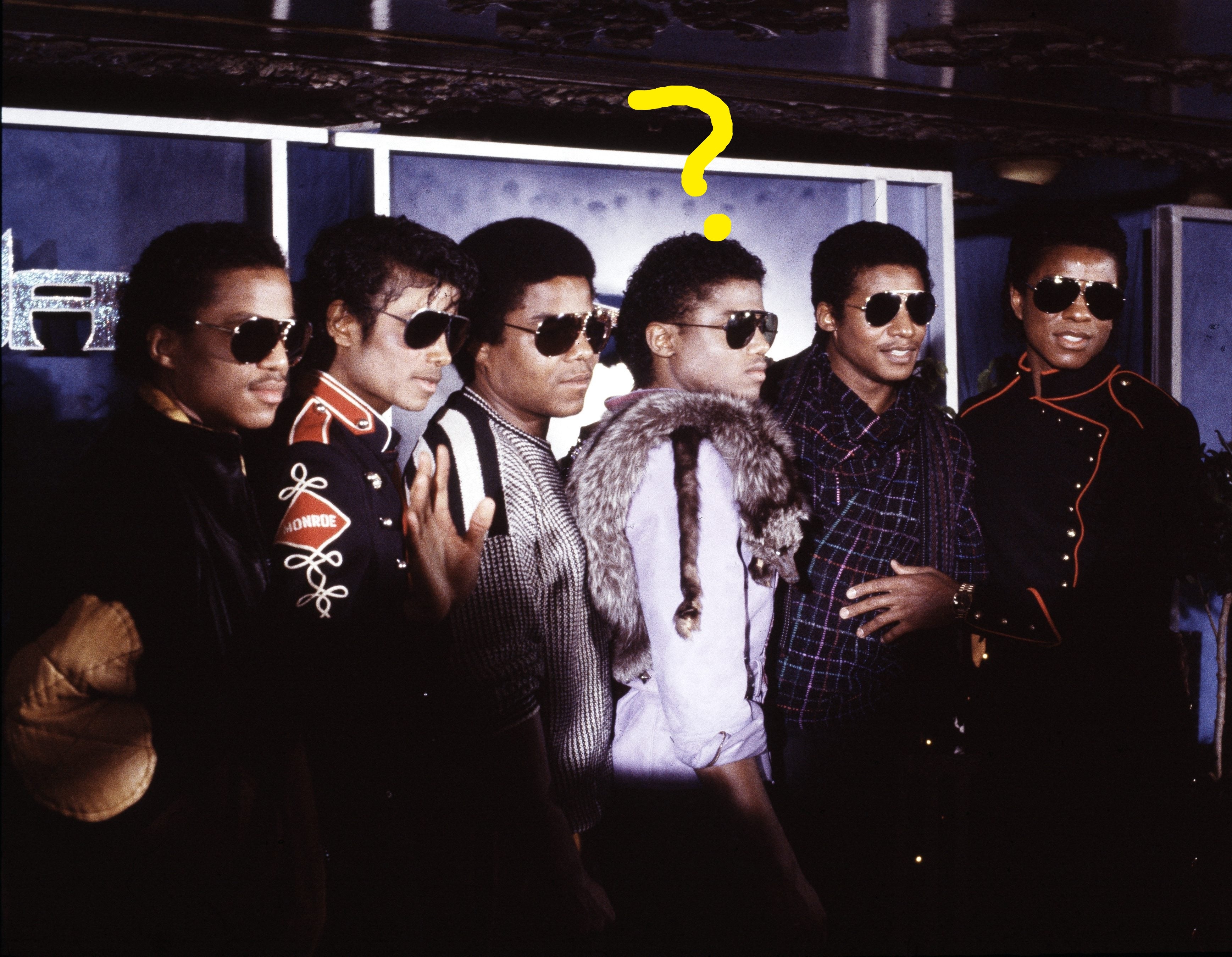 A radical  of six people, wearing stylish outfits and sunglasses, airs  unneurotic  astatine  a ceremonial  event